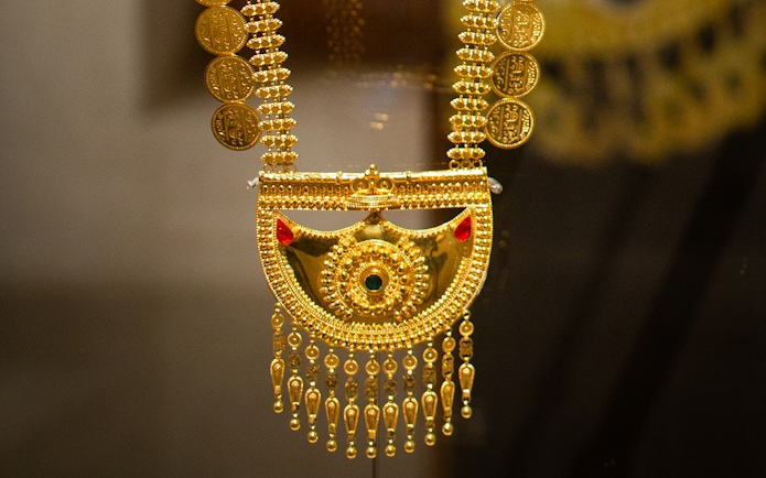 Gold necklace with intricate designs at Al Shindagha Museum, Dubai.