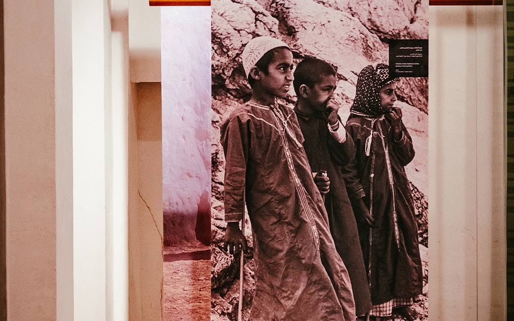 Children in traditional attire at Al Shindagha Museum exhibit, Dubai.