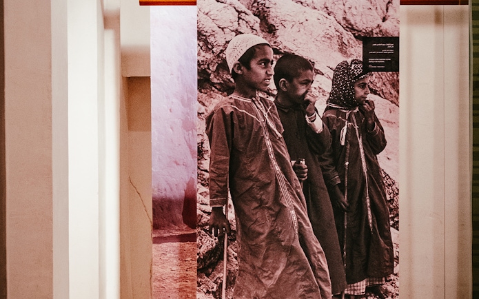Children in traditional attire at Al Shindagha Museum exhibit, Dubai.