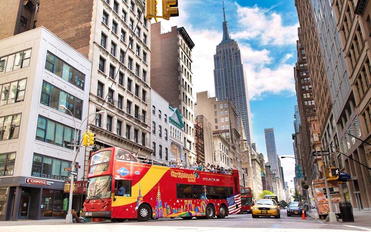 Open-top tour bus near Empire State Building, New York City.