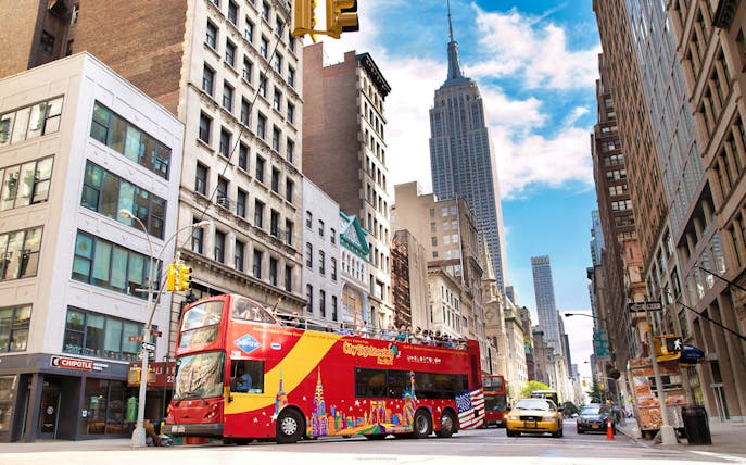 Open-top tour bus near Empire State Building, New York City.