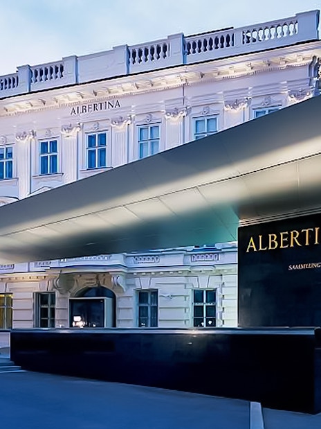 Albertina Museum entrance in Vienna at dusk.
