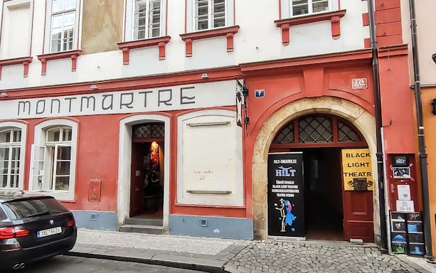 Entrance to Montmartre building with Black Light Theatre sign in Prague.