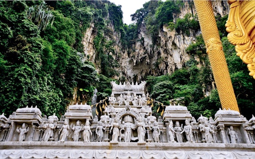 Batu Caves limestone hill with intricate Hindu temple carvings, Malaysia.