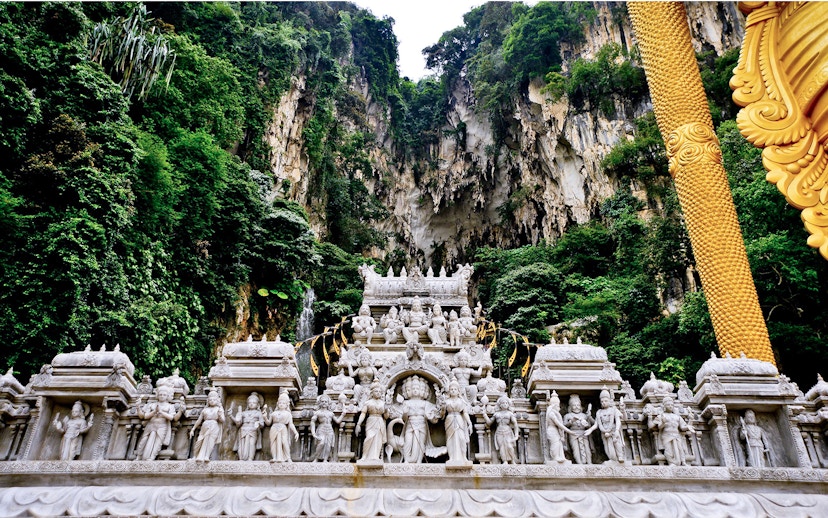 Batu Caves limestone hill with intricate Hindu temple carvings, Malaysia.
