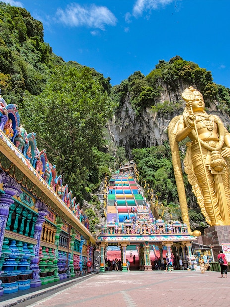Colorful steps and large statue at Batu Caves, Malaysia, part of Colmar Tropicale day tour.