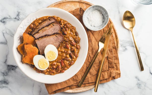 Traditional Hungarian cholent with beef, eggs, and sweet potatoes served in Budapest.