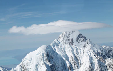 Mt Cook snow-covered peak with clouds, view from Lake Tekapo tour, Christchurch.