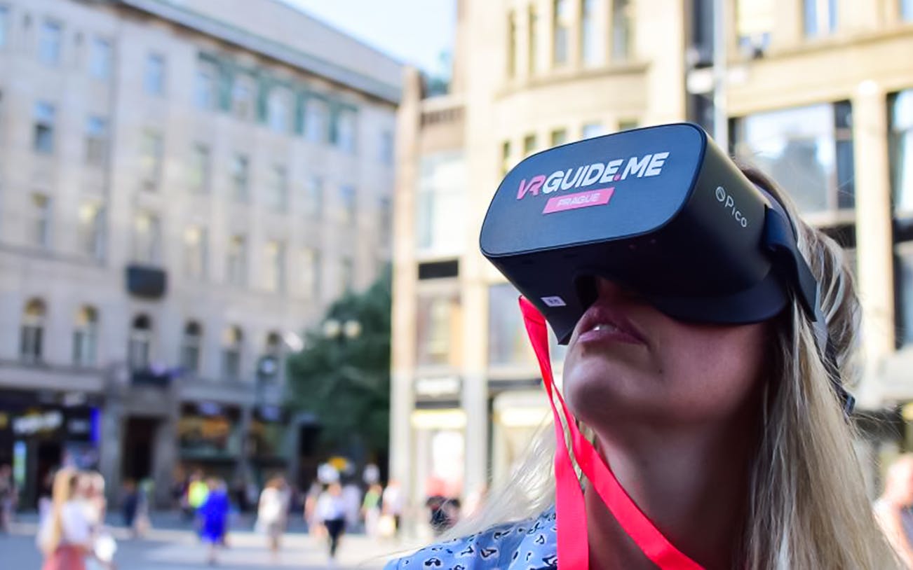 Person using VR headset on Charles Bridge tour in Prague.