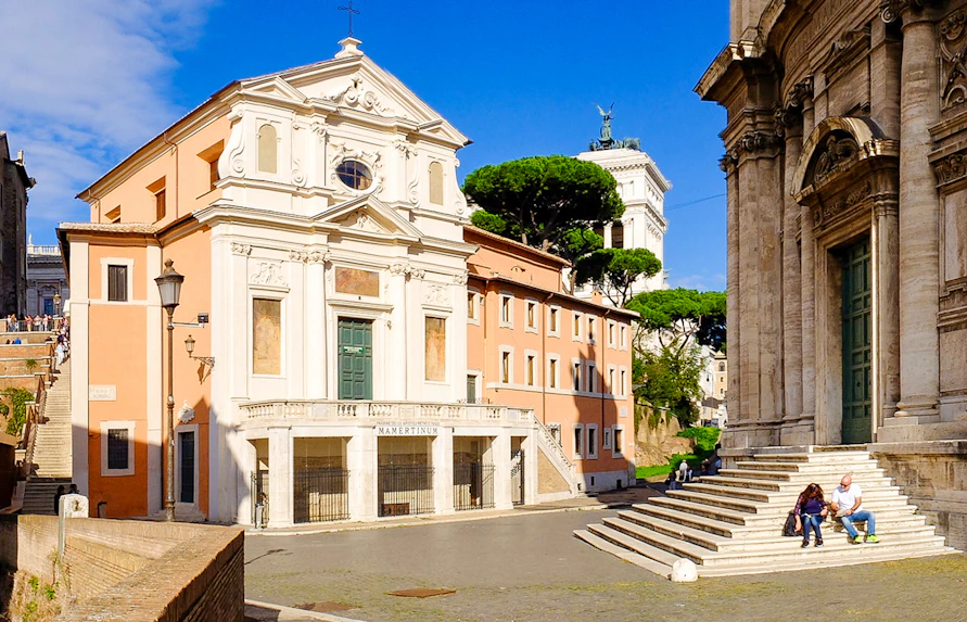 Mamertine Prison entrance in Rome with nearby historical buildings.