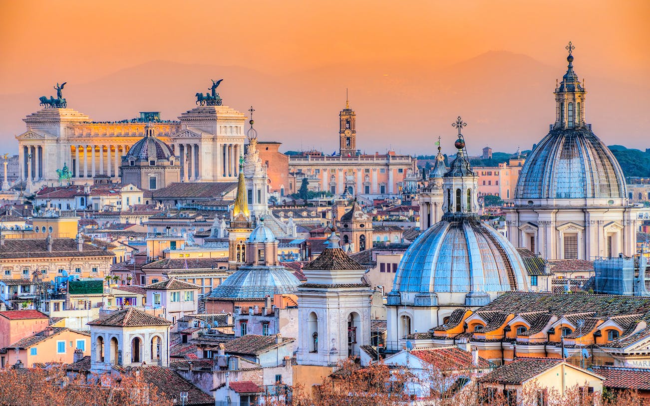 Rome skyline with domes and the Vittoriano monument at sunset, related to Roma Pass and Carcer Tullianum.