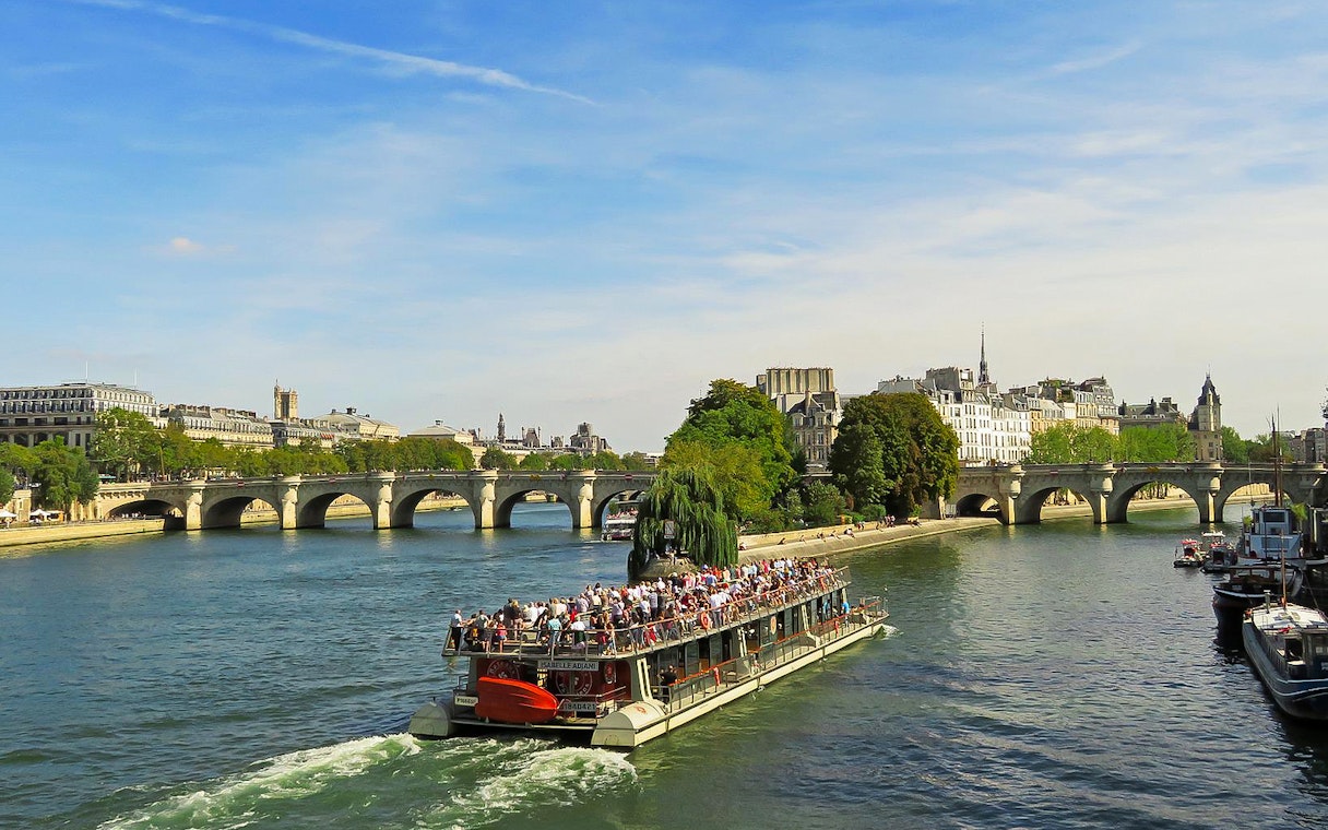 Seine River cruise near Pont Neuf, Paris, part of Musée d'Orsay tour.