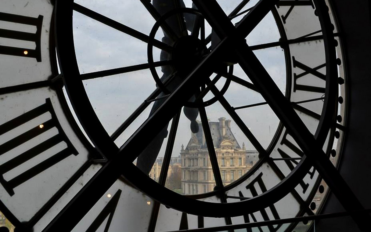 Clock view from Musée d'Orsay overlooking Parisian architecture.
