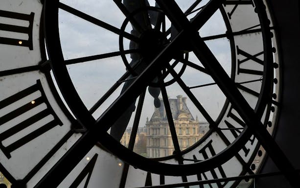Clock view from Musée d'Orsay overlooking Parisian architecture.