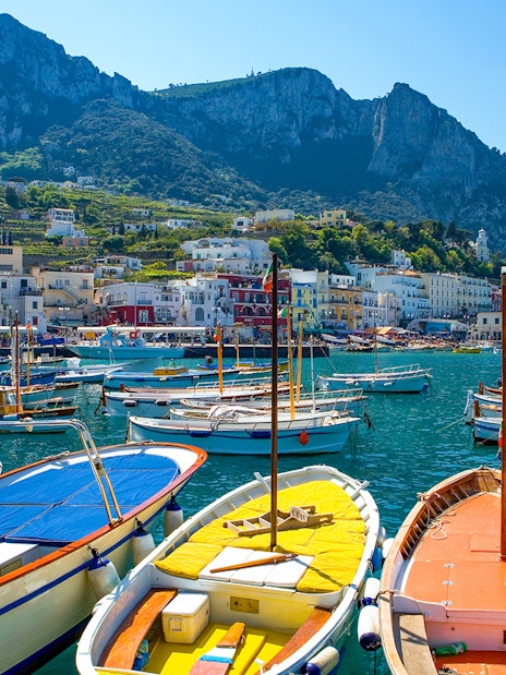 Boats docked at Marina Grande with Capri's cliffs in the background, Island of Capri.