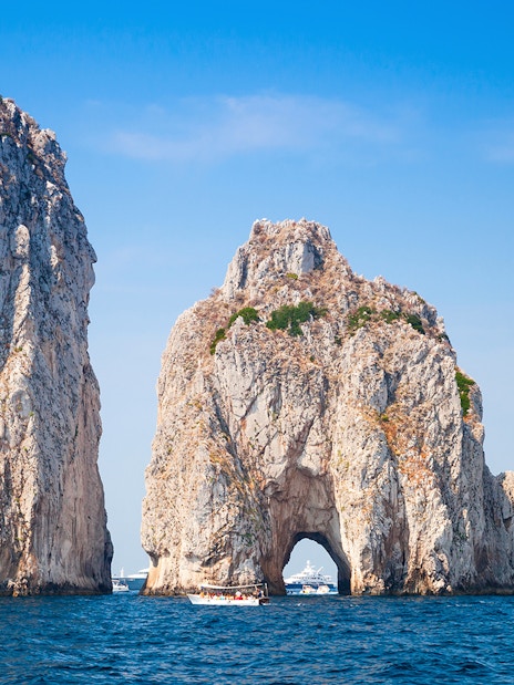 Faraglioni rock formations in Capri, Italy, viewed from the sea during a boat tour.