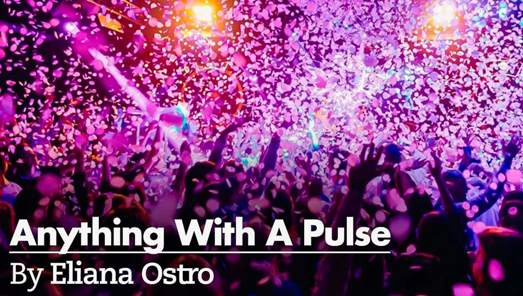 Crowd enjoying a vibrant confetti shower at a lively event.