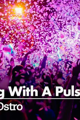 Crowd enjoying a vibrant confetti shower at a lively event.