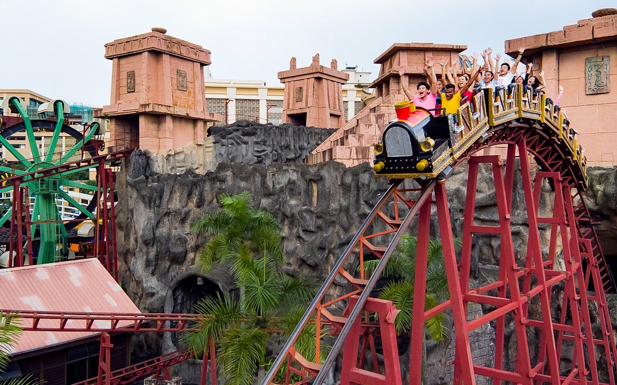 Roller coaster ride at Sunway Lagoon with excited visitors, Malaysia.