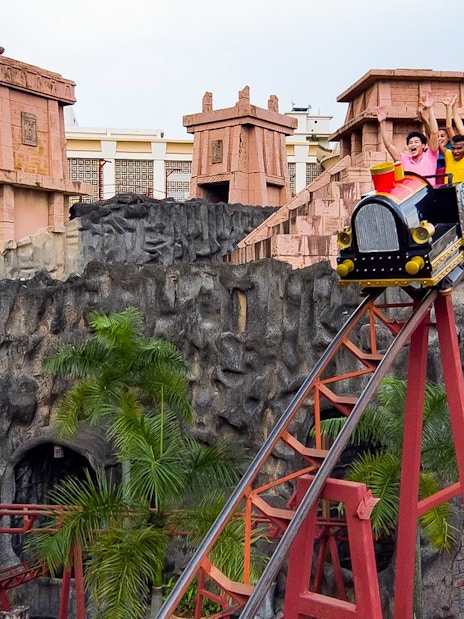Roller coaster ride at Sunway Lagoon with excited visitors, Malaysia.