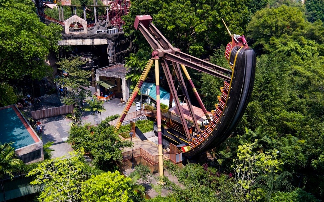 Sunway Lagoon amusement park ride surrounded by lush greenery.