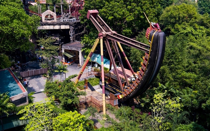 Sunway Lagoon amusement park ride surrounded by lush greenery.