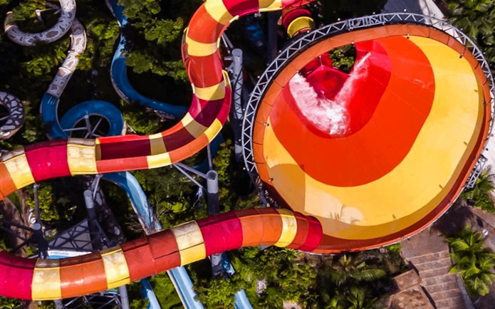 Water slide at Sunway Lagoon, Malaysia, surrounded by lush greenery.