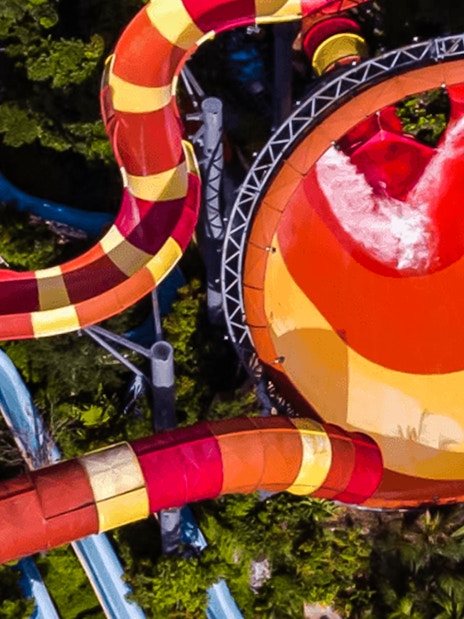 Water slide at Sunway Lagoon, Malaysia, surrounded by lush greenery.