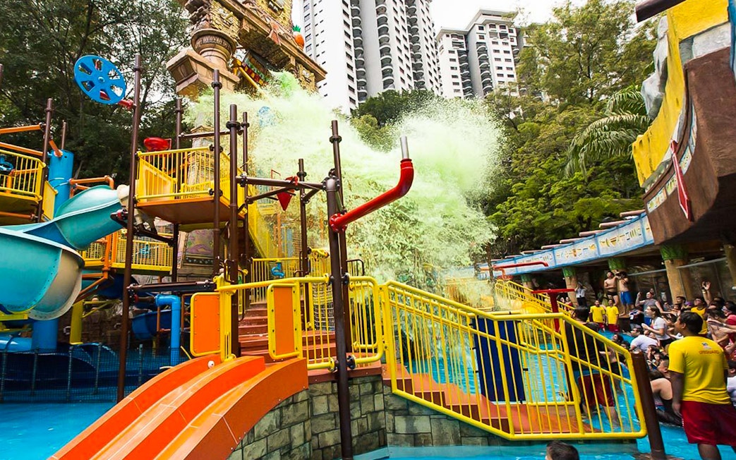 Sunway Lagoon water park splash area with slides and visitors in Kuala Lumpur.
