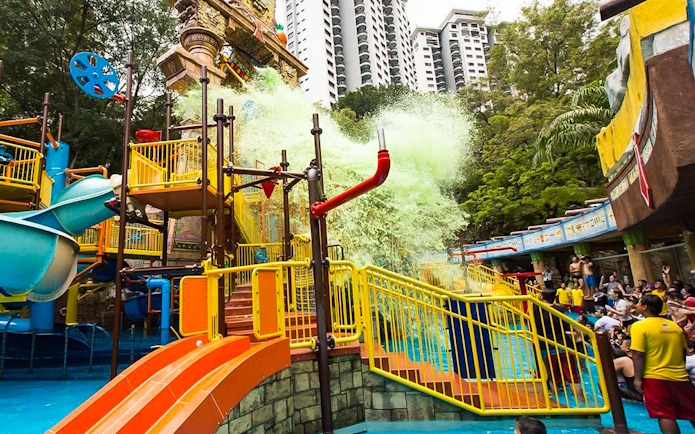Sunway Lagoon water park splash area with slides and visitors in Kuala Lumpur.