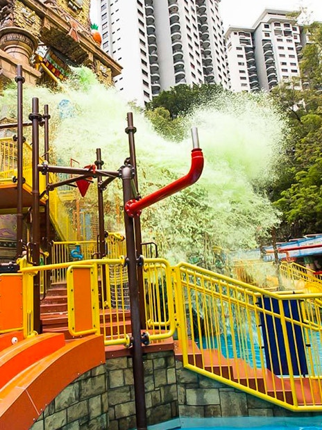 Sunway Lagoon water park splash area with slides and visitors in Kuala Lumpur.