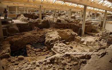 Akrotiri archaeological site ruins with walkways and viewing platforms.
