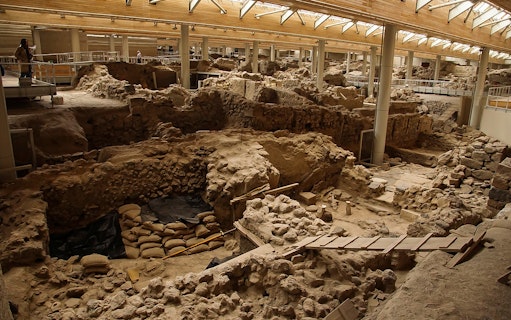 Akrotiri archaeological site ruins with walkways and viewing platforms.