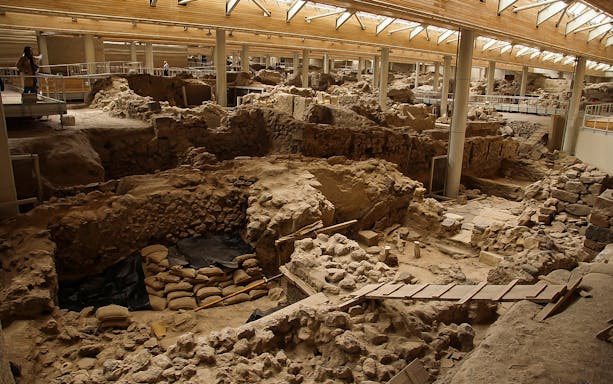Akrotiri archaeological site ruins with walkways and viewing platforms.