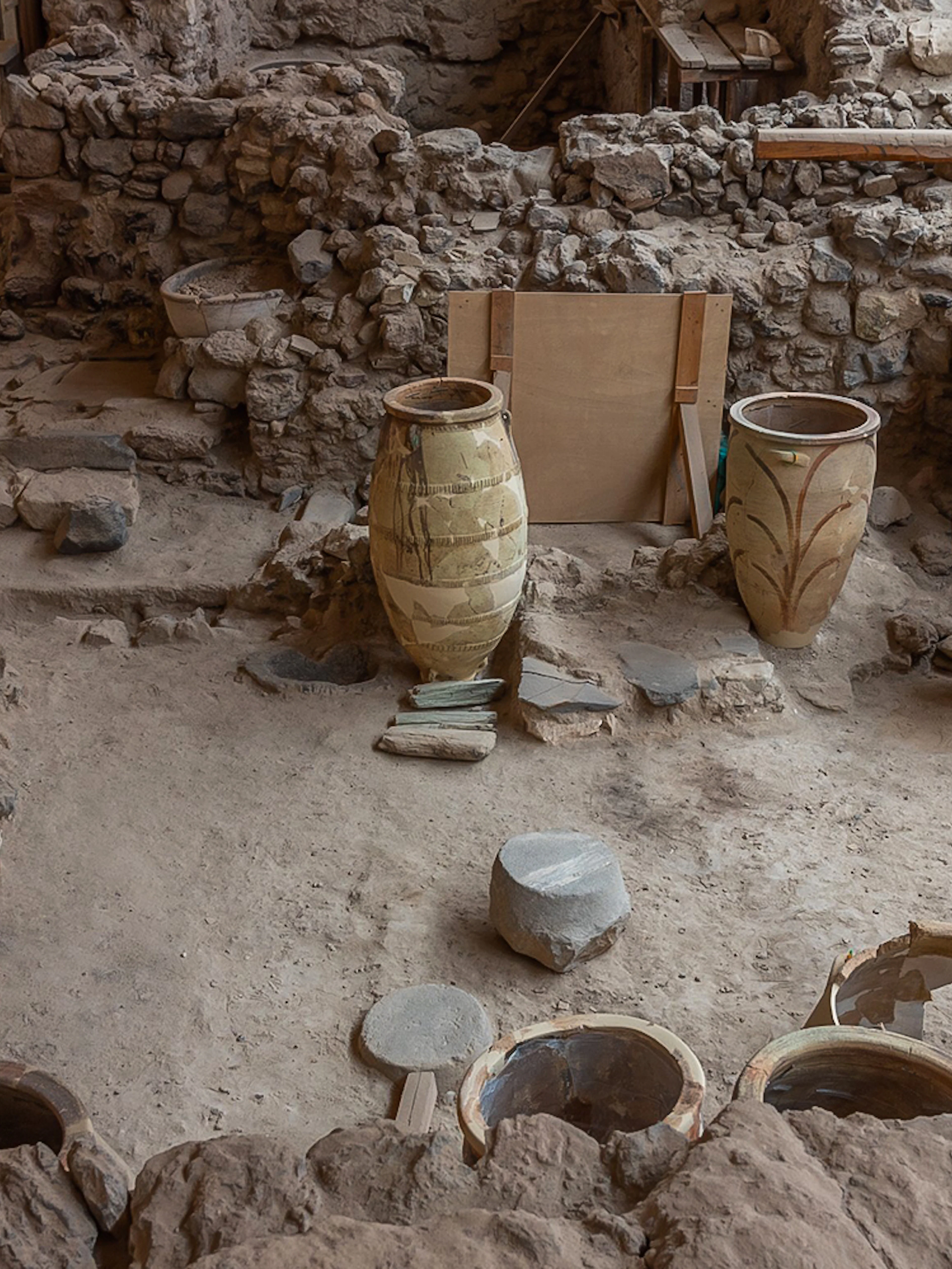 Ancient pottery and ruins at Akrotiri archaeological site in Santorini, Greece.
