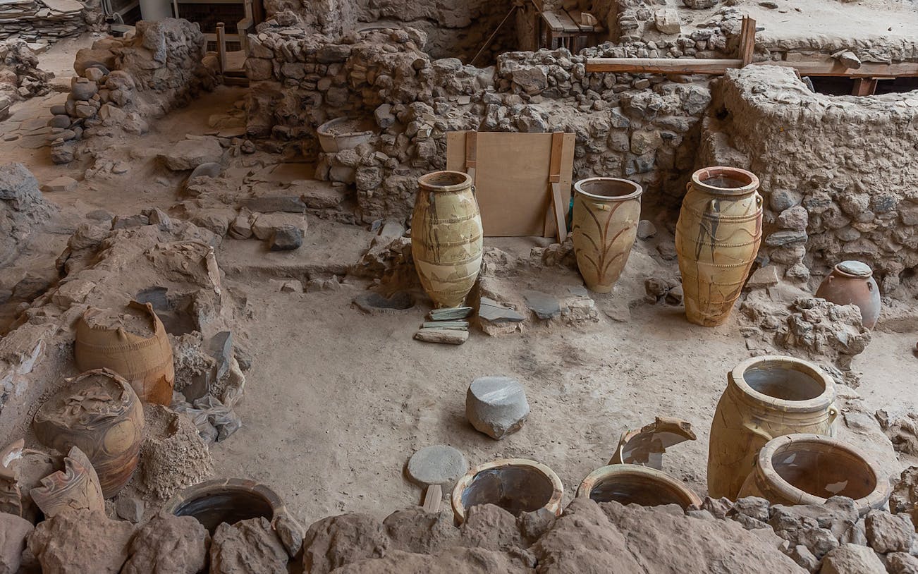 Ancient pottery and ruins at Akrotiri archaeological site in Santorini, Greece.