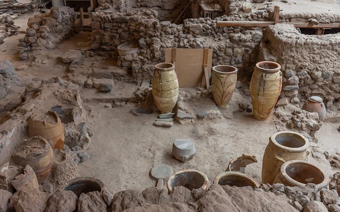 Ancient pottery and ruins at Akrotiri archaeological site in Santorini, Greece.