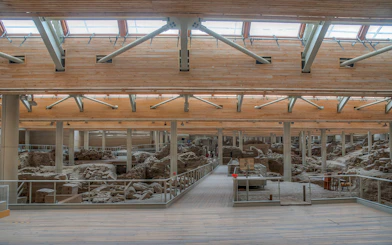 Akrotiri archaeological site interior with ancient ruins and walkways.