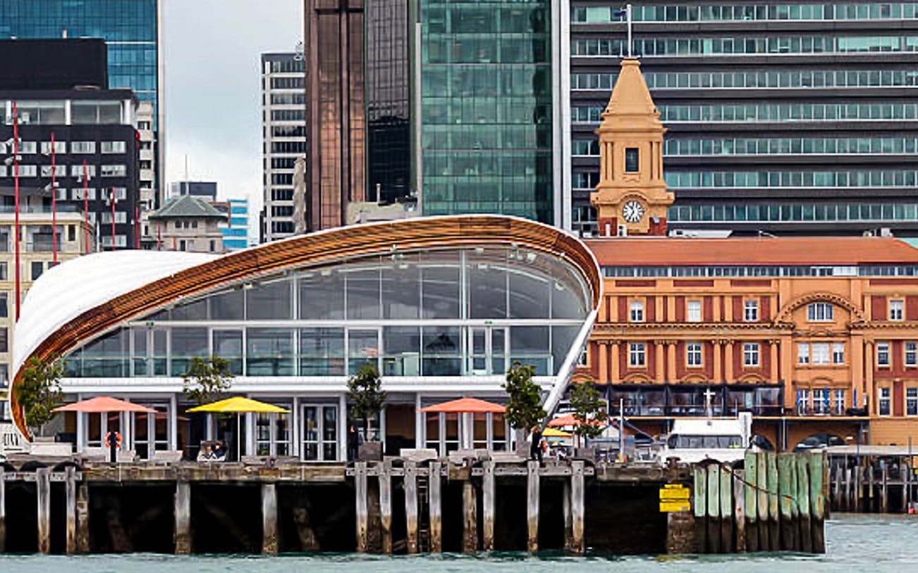 Auckland waterfront with modern architecture and historic ferry building.