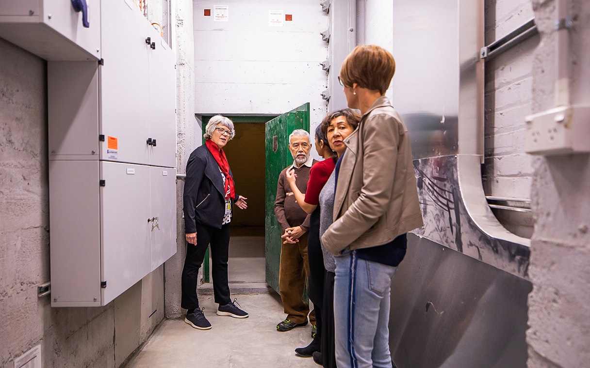 Group touring Auckland War Memorial Museum's underground area.
