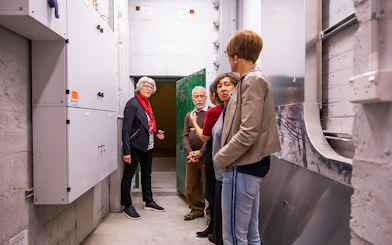 Group touring Auckland War Memorial Museum's underground area.