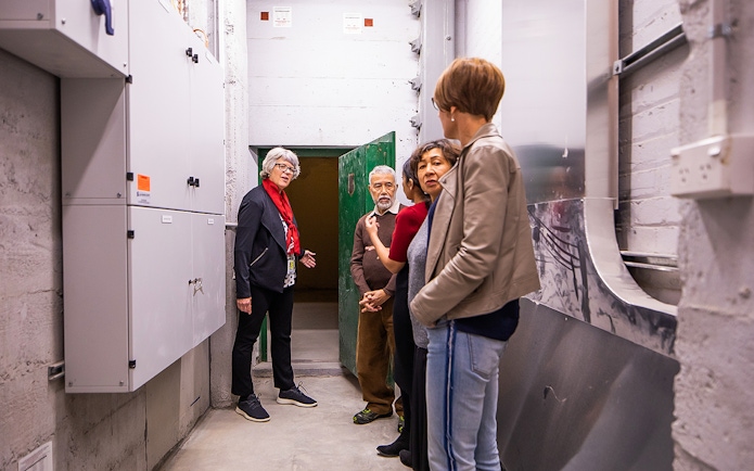 Group touring Auckland War Memorial Museum's underground area.