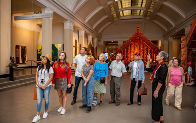 Visitors exploring the Auckland War Memorial Museum with a guide.