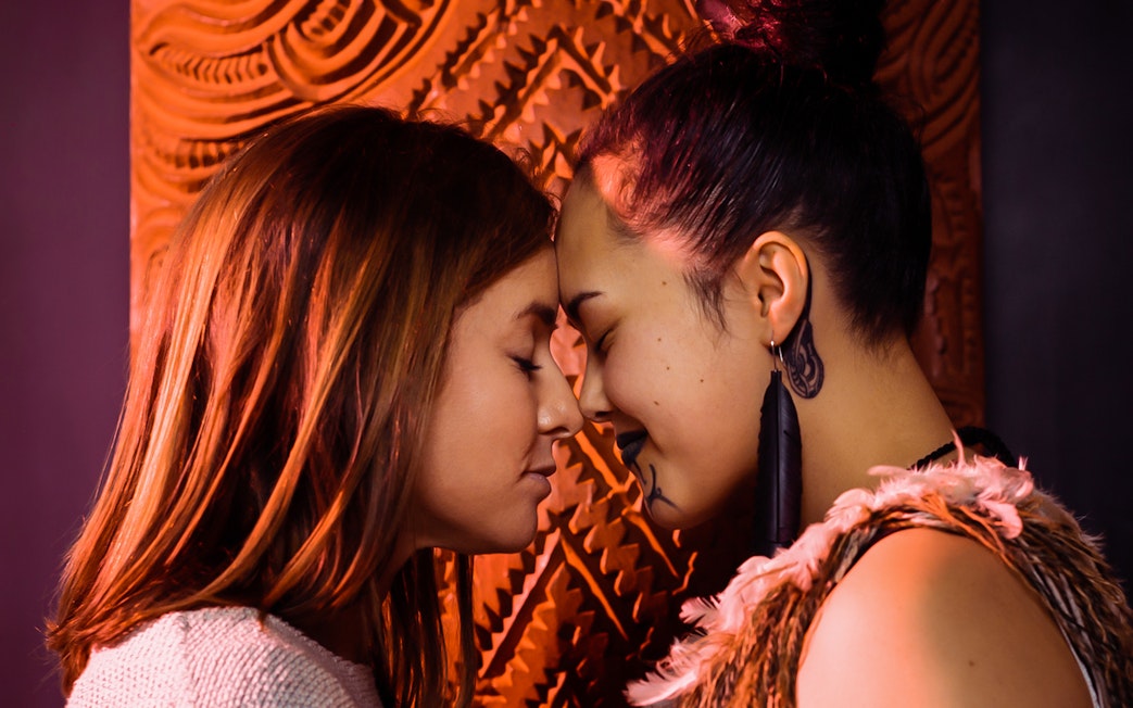 Two people sharing a hongi at Auckland War Memorial Museum.