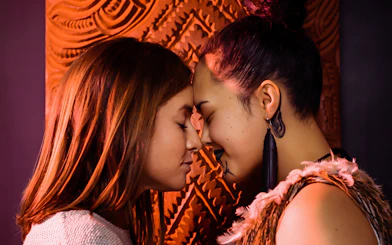 Two people sharing a hongi at Auckland War Memorial Museum.