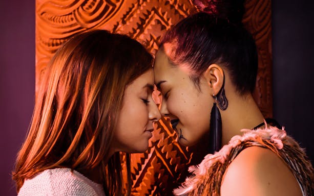 Two people sharing a hongi at Auckland War Memorial Museum.