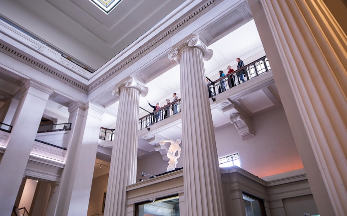 Auckland War Memorial Museum interior with visitors on upper balcony.