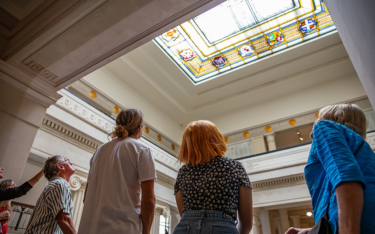 Visitors admiring stained glass ceiling at Auckland War Memorial Museum.