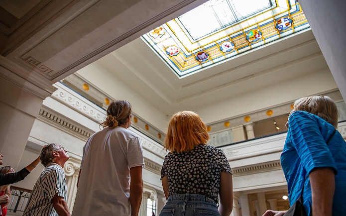 Visitors admiring stained glass ceiling at Auckland War Memorial Museum.