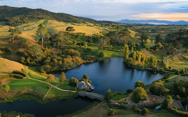 Hobbiton Movie Set landscape with lake and hills, viewed from Rotorua tour.